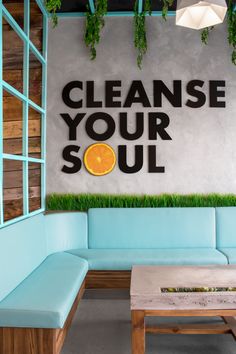 a couch and table in front of a sign that says cleanse your soul