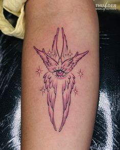 a tattoo on the leg of a woman with pink wings and stars around her arm