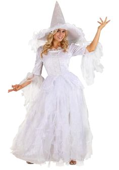 a woman in a white dress and hat with her arms out, wearing a wizard costume