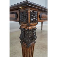 an ornately carved table with two legs