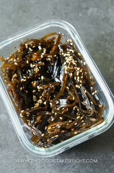 seaweed in a plastic container with sesame seeds