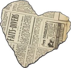 an old newspaper heart cut out into the shape of a paper