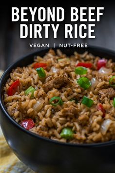 a black bowl filled with rice and veggies