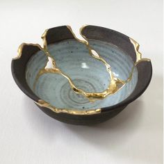 a black and gold bowl on a white table