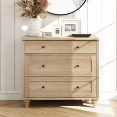 a wooden dresser sitting in front of a white wall