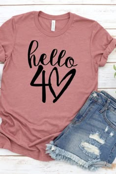 If you're looking for a stylish gift how about getting one of these cool 'Hello Forty' t-shirts that comes in a number of different colors? It's a great gift for a fashionista that loves posting selfies or TikTok videos! See more party ideas and share yours at CatchMyParty.com 40 Shirts For Women, 40s Birthday Party Ideas For Women, 40tg Birthday Ideas For Women, Hello Forty, Hello 40, 40 Shirt, 40th Birthday Gifts For Women