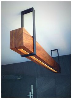 a wooden light fixture hanging from the ceiling