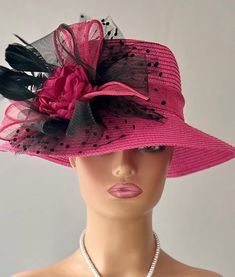 The featured hat is a fuchsia  straw hat with a black crinoline flower, black netting, black feathers and a fuchsia center fabric flower. This hat is so eye popping and gorgeous  it's a must have for any woman who loves hats. This  hat is a beautiful church hat or a Kentucky Derby Hat.  Also perfect  for an Easter Hat, Tea Party hat,Wedding Party Hat, Fancy Dress Hat , Downton Abby hat and any other special occasion. Brim:   3" Rise:   4" Size:   22" Pink Fedora Sun Hat For Party, Fedora Straw Hat For Church And Kentucky Derby, Kentucky Derby Fedora Straw Hat For Church, Mini Fedora Hats For Kentucky Derby Garden Party, Fedora Straw Hat For Kentucky Derby And Church, Fedora Mini Hats For Kentucky Derby Garden Party, Pink Flat Brim Sun Hat For Party, Pink Fedora Sun Hat For Kentucky Derby, Pink Fedora Straw Hat For Kentucky Derby