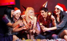 group of friends celebrating christmas with sparklers