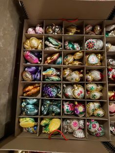 a box filled with lots of different colored ornaments