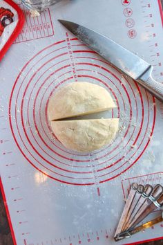 a loaf of bread sitting on top of a table next to scissors and measuring tape