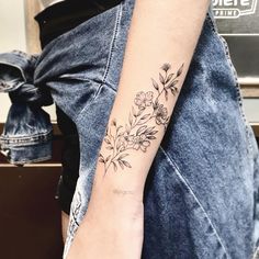 a woman with a flower tattoo on her arm