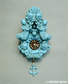 a blue clock that is on the wall