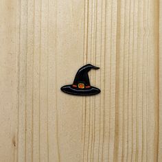 a wooden door with a witches hat on it