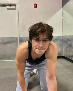 a young man is doing push ups on the floor