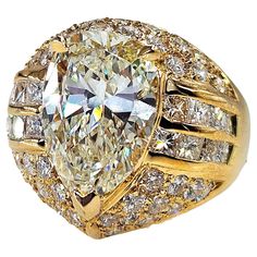 Fantastic Vintage rich smooth buttery 18K Yellow Gold Diamond Engagement Ring. CIRCA 1990s. The Transitional GIA certified 3.80ct Pear shaped Center Diamond in K color SI1 clarity is super sparkling, eye clear and faces up warm White! Well cut and appears larger than a 4ct Diamond. You will keep looking into this Diamond endlessly! The Pear is set into a masterpiece of a mounting! You have 39 round brilliant full cut diamonds, pave set together with 16 channel set Princess cut Diamonds in G-H-I color, VS clarity over all. Estimated total weight of the accent diamonds is 2.70ct. The ring is very substantial and solid, weights 8.67 grams. The widths is 17.5mm North to South and 18.38 West to East. The band tappers from 10.39 to 5.23mm on the bottom. Finger size is 6 , can be re-sized. Hallma Luxury Vintage Yellow Gold Diamond Ring, Luxury Yellow Pear-shaped Ring, Luxury Vintage Yellow Rings, Luxury Yellow Sapphire Ring, Fine Jewelry, Canary Yellow Diamond Ring 1stdibs, Gold Band Wedding Ring, Yellow Gold Diamond Engagement Ring, Emerald Cut Diamond Engagement, Gold Diamond Engagement Ring