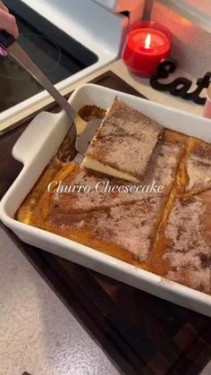 someone is cutting into a cake in a pan on the stove with a spatula