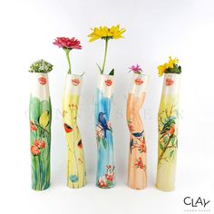 four vases with flowers painted on them are lined up against a white background,