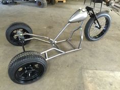 an unusual looking bike is parked in a garage