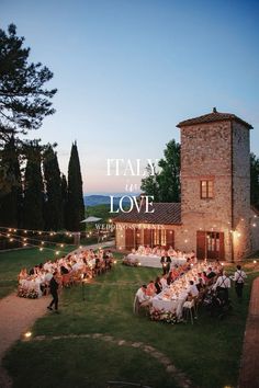 an outdoor dining area with tables and chairs in front of a stone building that says it's all in love