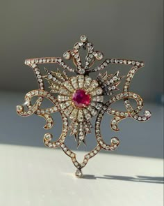 Handmade Brooch Recycling: No Silver weight: 23.800 Grams Brooch: Length: 2.50 Inches Brooch width: 2.50 Inches Gemstone: American Diamond (zircon) & Ruby Diamond weight: 8.21 ct Diamond shape: Round Diamond colure: white Ruby weight: 2.90 Ruby: Lab created Material: Silver Silver purity: 925 Stone putting: Prongs & Pave Brooch Finished: Oxidized Black & Gold plated Luxury Brooches With Rose Cut Diamonds, Fine Jewelry Diamond Gemstone Brooches, Luxury Brooches With Intricate Design, Luxury Diamond Pendant Brooches, Victorian White Gold Pendant Brooches, Luxury Diamond White Brooch As Gift, Luxury Diamond Brooch With Rose Cut Diamonds, Luxury Brooches With Single Cut Diamonds, Luxury Diamond Brooches