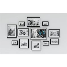 a group of black and white photos hanging on a wall with multiple frames around them