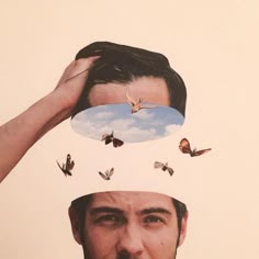 a man is holding his head with butterflies on it's forehead and the image of a sky above him