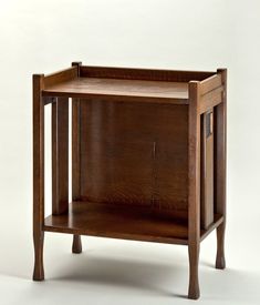 a small wooden cabinet sitting on top of a white floor