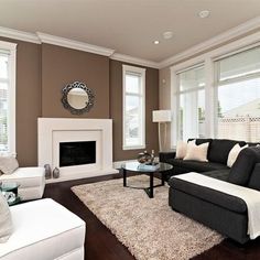 a living room filled with furniture and a fire place in the middle of a room