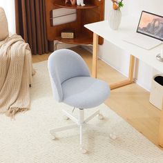 a blue chair sitting in front of a computer desk