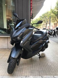 the motorcycle is parked on the side of the street