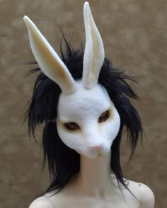 a white mask with black hair and ears