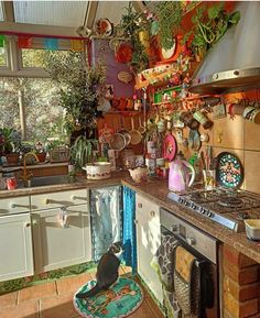 a kitchen filled with lots of pots and pans on top of a stove top oven