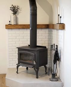 a black stove sitting in the corner of a room