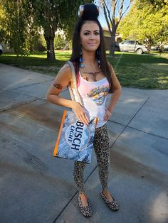 a woman is standing on the sidewalk holding a bag