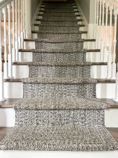 a carpeted staircase leading up to the second floor