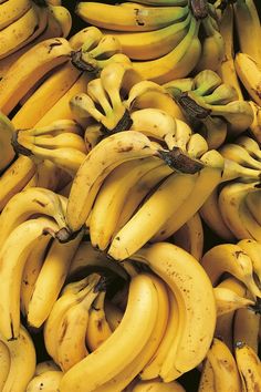 many bunches of bananas are stacked together in this pile and ready to be eaten