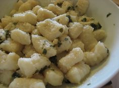 a white bowl filled with food on top of a table