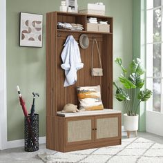 a room with a coat rack, umbrella and other items on the shelf in it