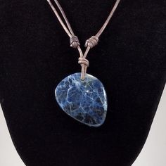 The Sodalite cabochon pendant is approximately 1.4 by 1.1 inches on natural gray polished round leather. The necklace is adjustable from 16 inches to 32 inches by sliding the knots. Sodalite is a rich royal blue tectosilicate mineral widely used as an ornamental gemstone. Although massive sodalite samples are opaque, crystals are usually transparent to translucent. Sodalite is a member of the sodalite group with hauyne, nosean, lazurite and tugtupite. First discovered by Europeans in 1811 in the Sterling Silver Earrings Handmade, Gray Polish, Kyanite Earrings, Round Leather, Cabochon Pendant, Leather Necklace, Ontario, Earrings Handmade, Handmade Necklaces