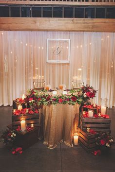 the table is set up with candles and flowers on it for an elegant wedding reception