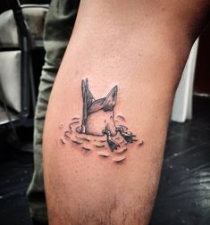 a man's leg with a tattoo of a bird in the water on it