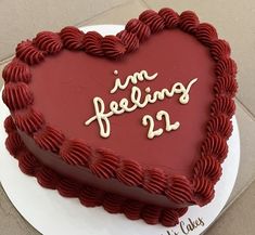 a heart shaped cake with the words i'm feeling 22 on it