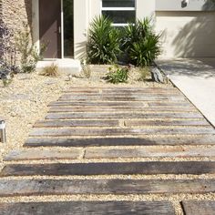 a wooden walkway in front of a house