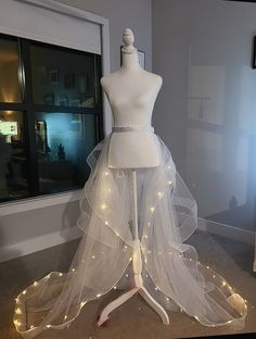 a white mannequin with lights around it