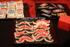 some cookies are sitting on a table with red and black napkins next to them