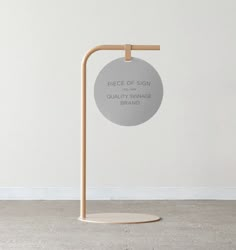 a sign that reads price of sign on the side of a white wall with a wooden stand