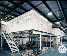 the inside of a warehouse with stairs and boxes