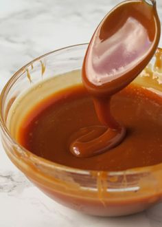 sauce being poured into a glass bowl