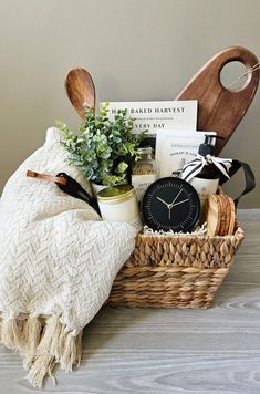 a basket filled with items sitting on top of a wooden table next to a clock